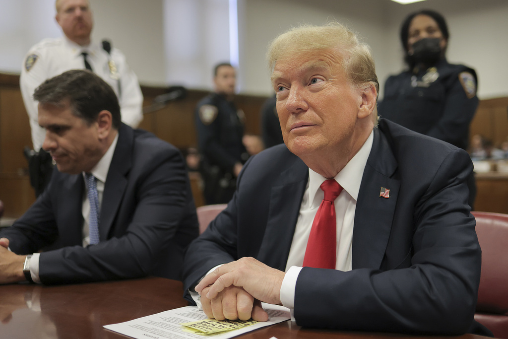 Former President Donald Trump sitting in a courtroom.