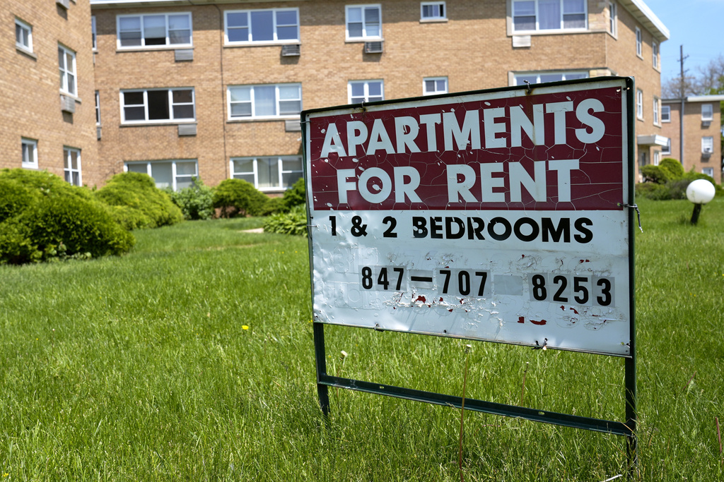 A "Apartments For Rent" sign displays outside apartment building in Skokie, Ill., Wednesday, May 15, 2024.
