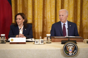 VP Kamala Harris and President Joe Biden sitting at a table.