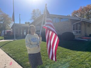 woman holds flag