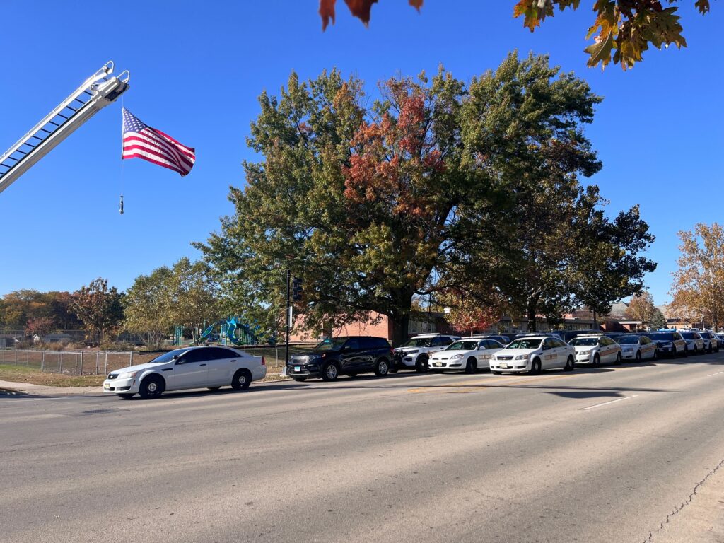 street with US flag and police vehicles