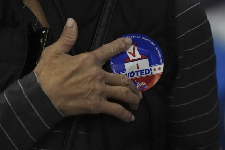 hand in front of voting sticker