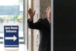 Former Illinois House Speaker Michael Madigan waves as he leaves the Dirksen Federal Courthouse.