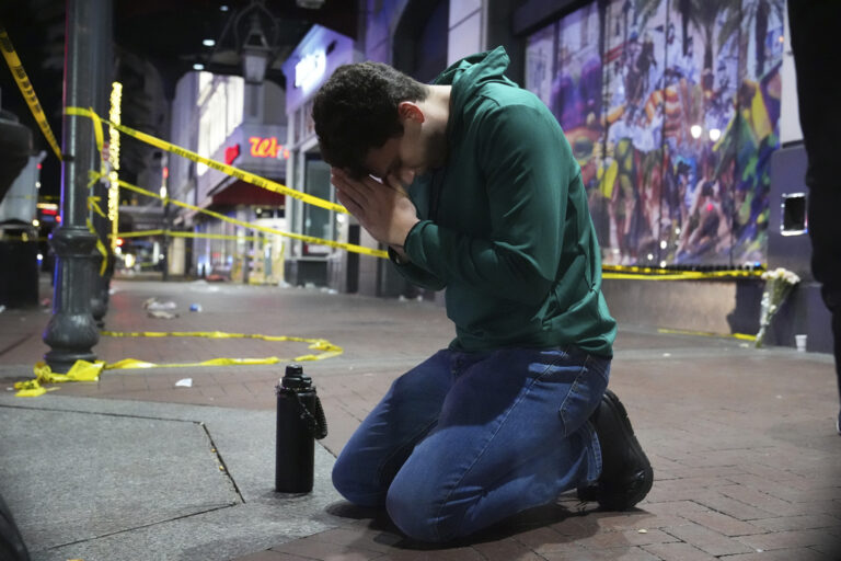 man kneeling on street