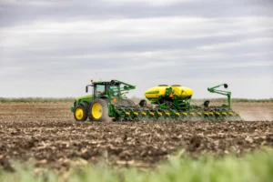 A tractor in operation on crop fields