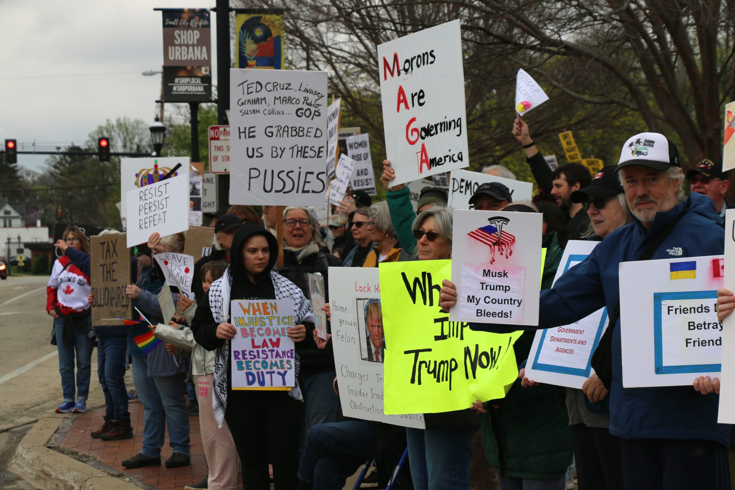 demonstrators hold signs