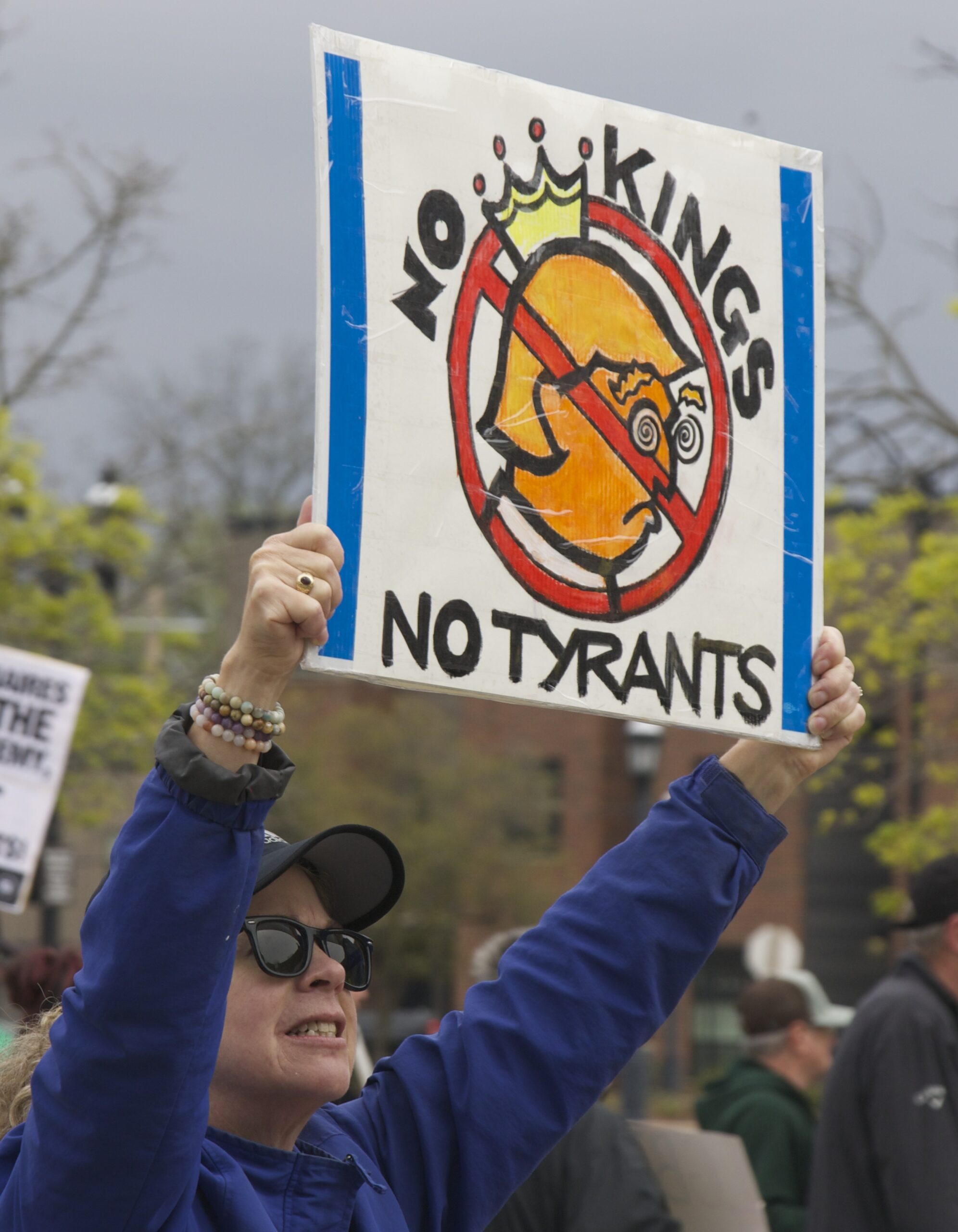 demonstrators holding up sign