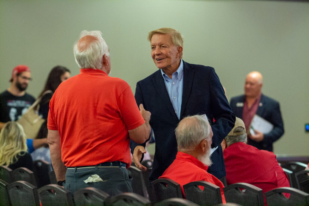 man shakes another man's hand