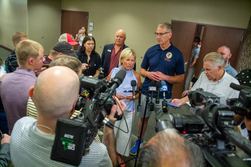 woman speaks to press