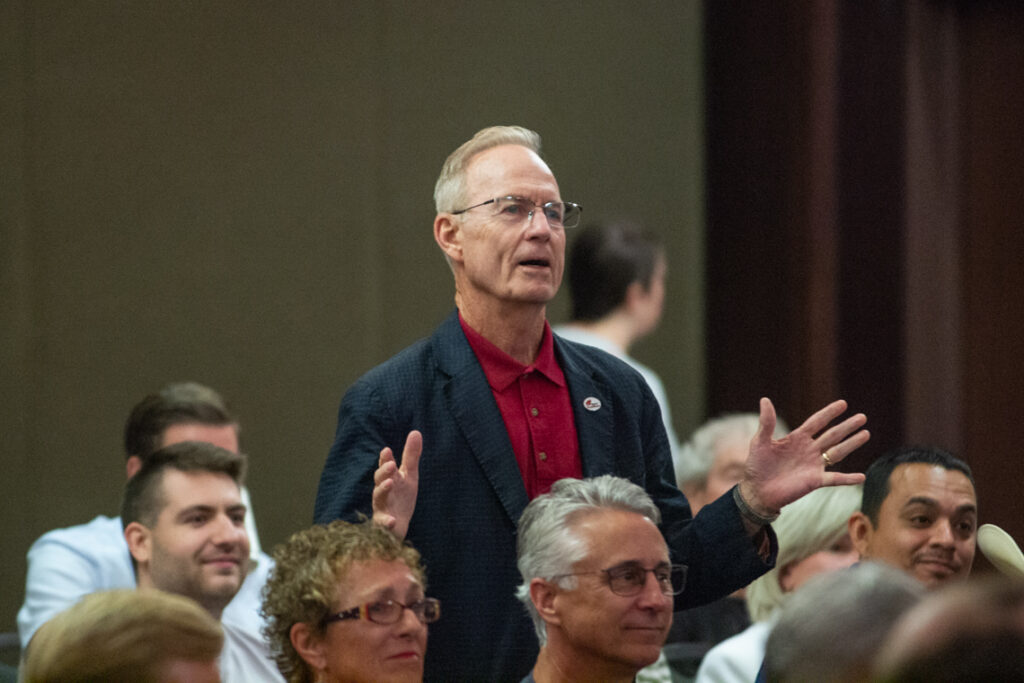 man speaking in a crowd