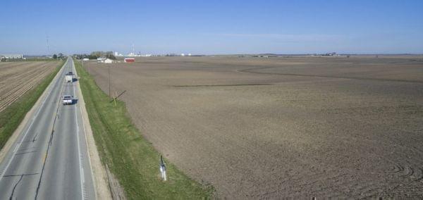 an aerial photo with a road and an agricultural field