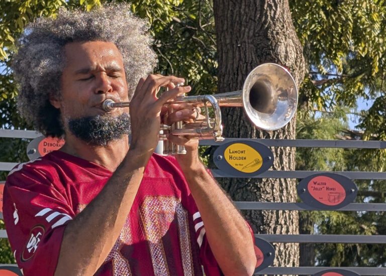 man playing the trumpet outside