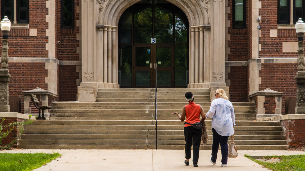 Angela Patterson and Laura Hastings walk towards school steps.