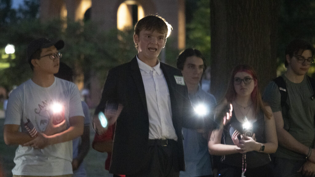 man speaks at vigil