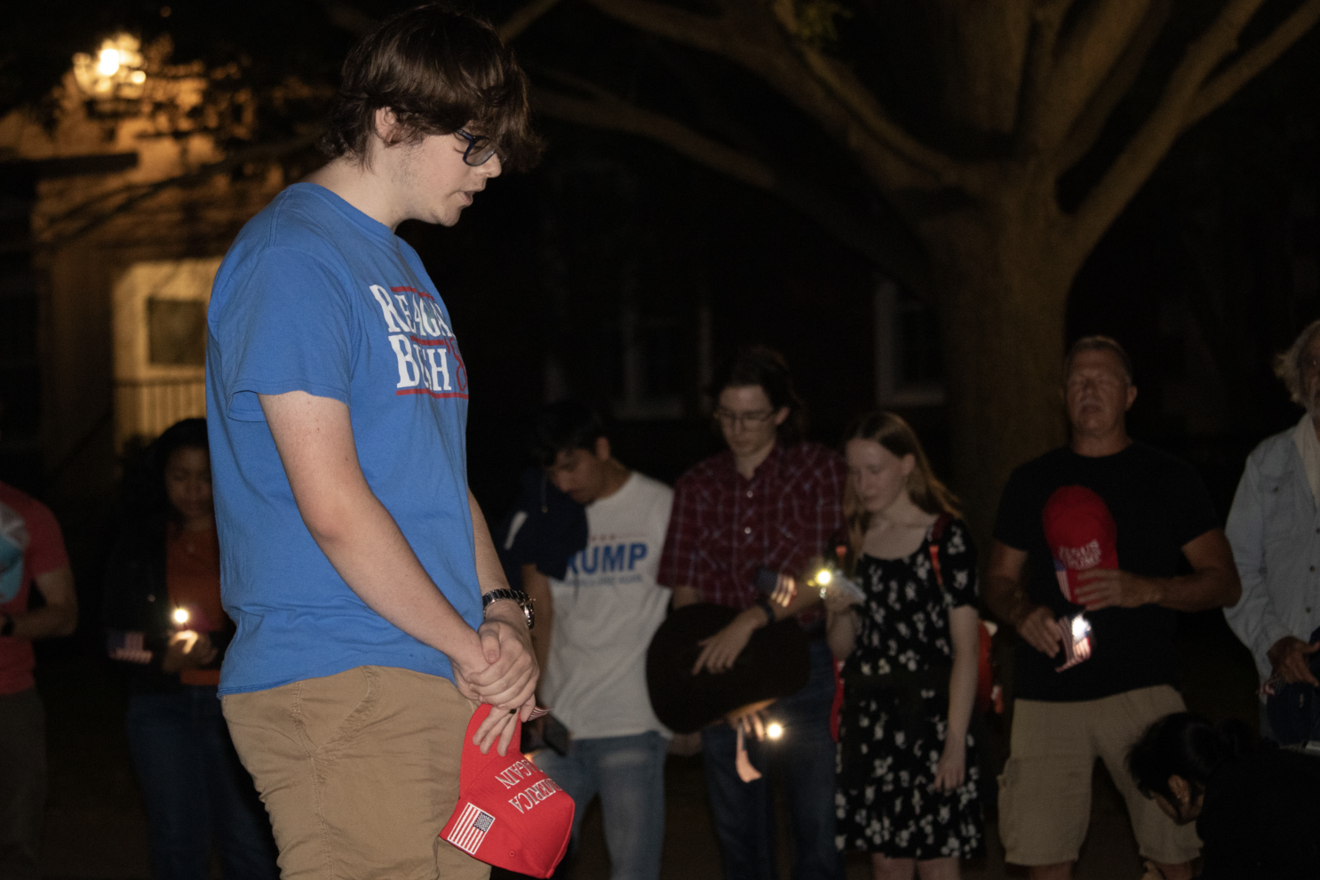 man praying at vigil