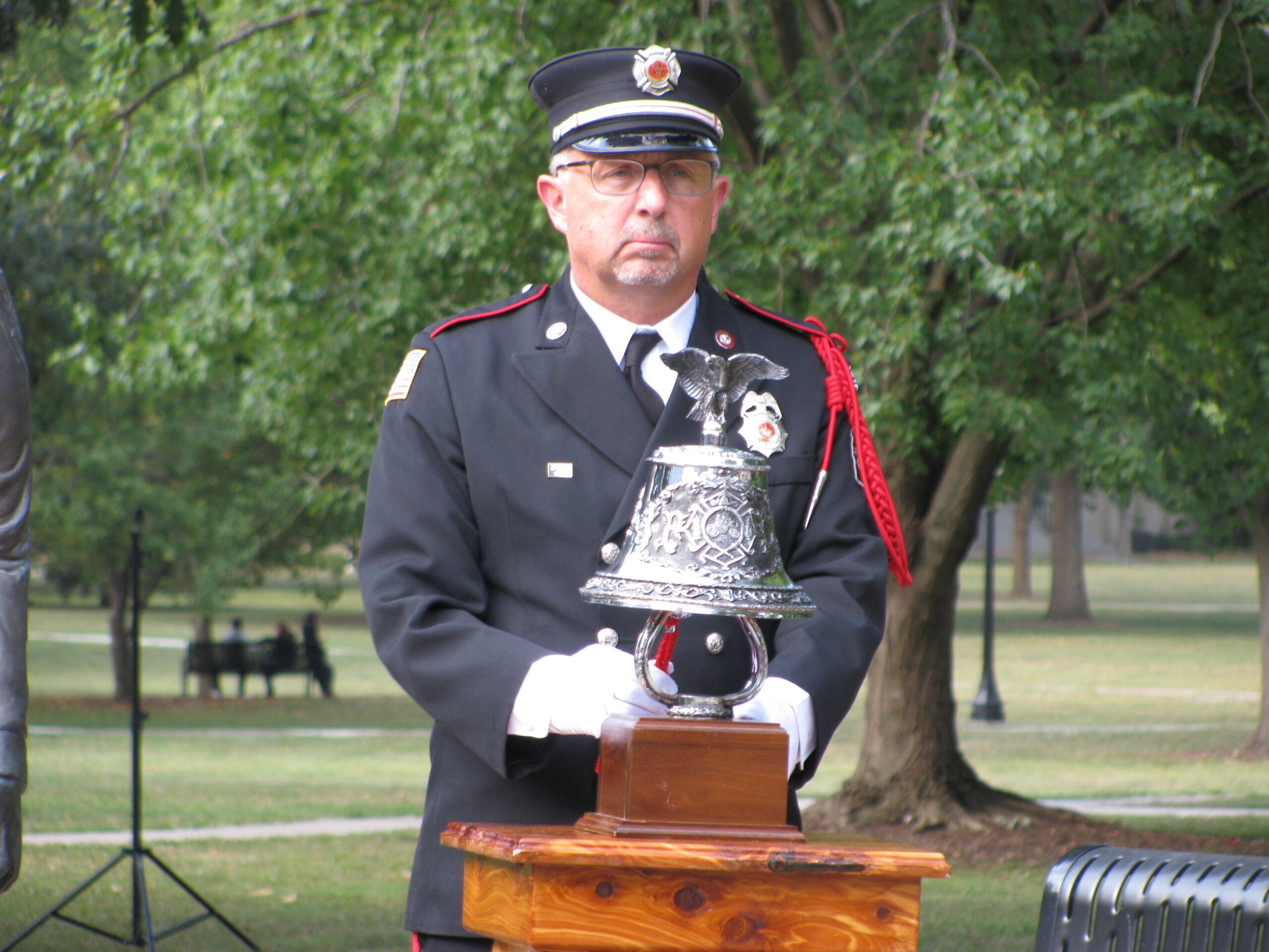 Honor Guard member Curtis Hays tolling a bell in threes. This is done to signify the end of a comrade’s duty.