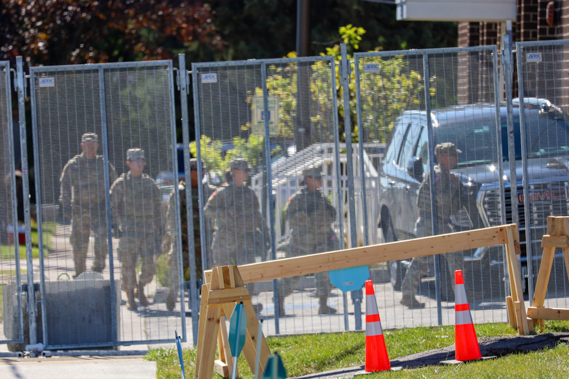 A group of people in military fatigues walks into an Immigration and Customs Enforcement facility in Broadview on Thursday, Oct. 9. National Guard troops were deployed to the facility earlier in the day.