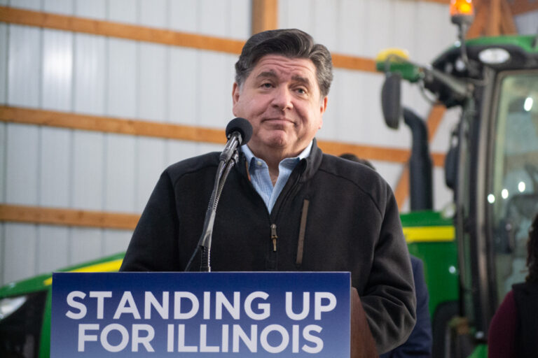 Gov Pritzker standing at podium