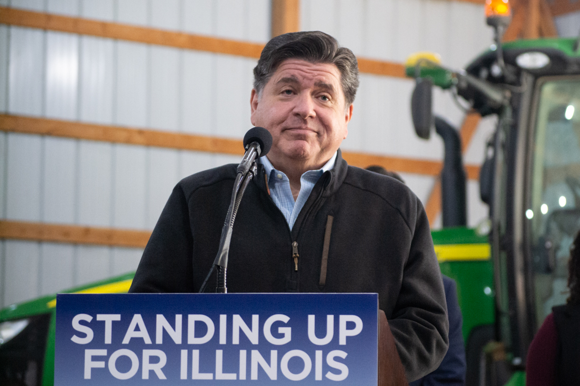 Gov Pritzker standing at podium