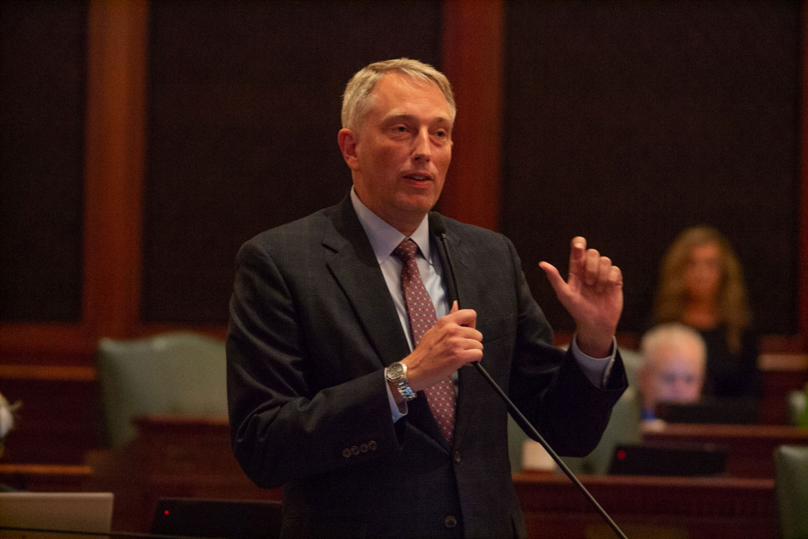 man speaking at IL general assembly