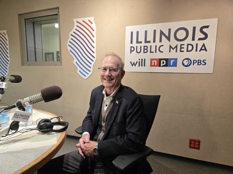Don Tracy sits in front of a microphone in the Illinois Public Media studio.