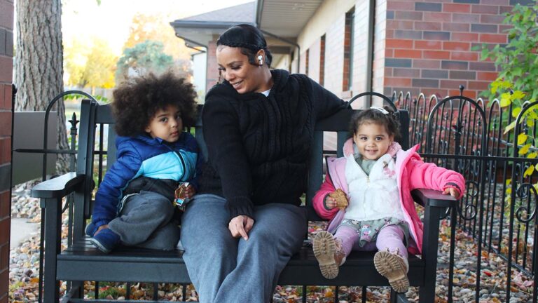 Taishana Brown picked up her kids, Legend (left) and Legacy (right), from Head Start Wednesday, and picked up a box of food at the same time.