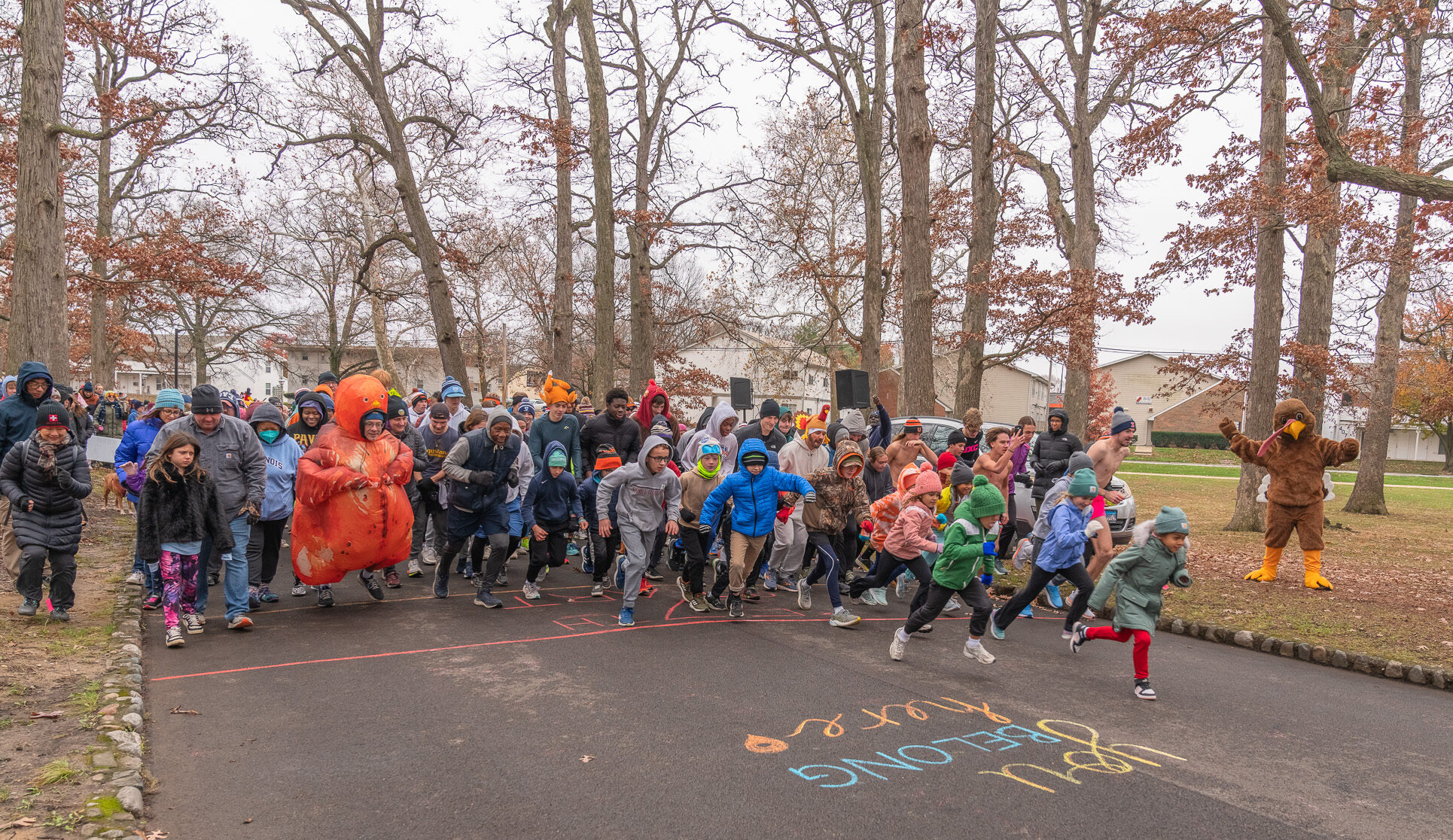 A group of people run on pavement.