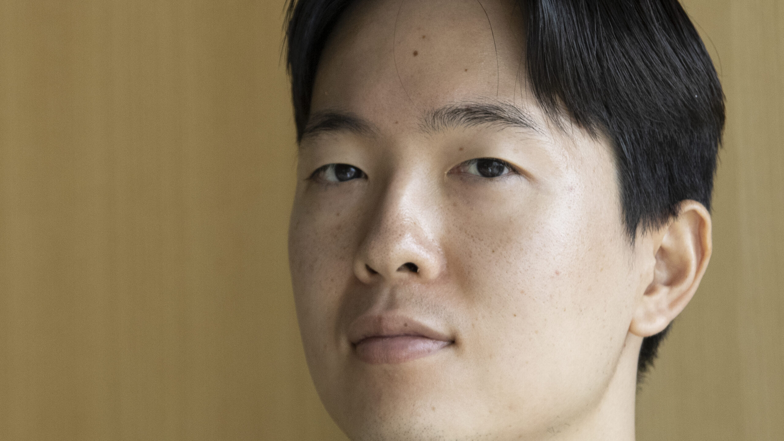 A close-up view of a young man's face.
