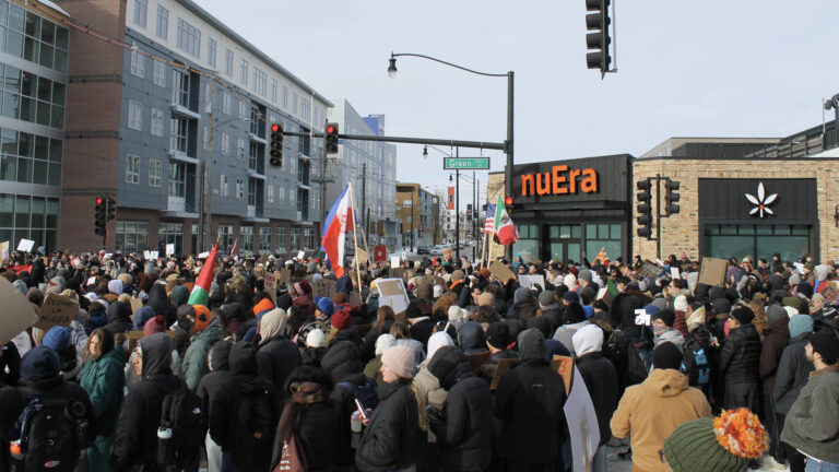 Thousands of people fill the intersection of Green Street and First Street.
