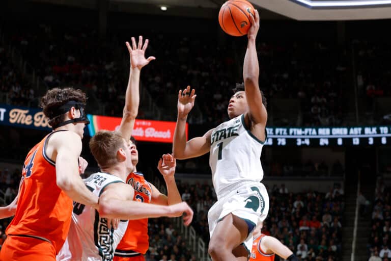 Michigan State guard Jeremy Fears Jr. (1), right, goes up to shoot against Illinois center Zvonimir Ivisic, left, and guard Andrej Stojakovic, third from left, during the second half of an NCAA college basketball game, Saturday, Feb. 7, 2026, in East Lansing, Mich.