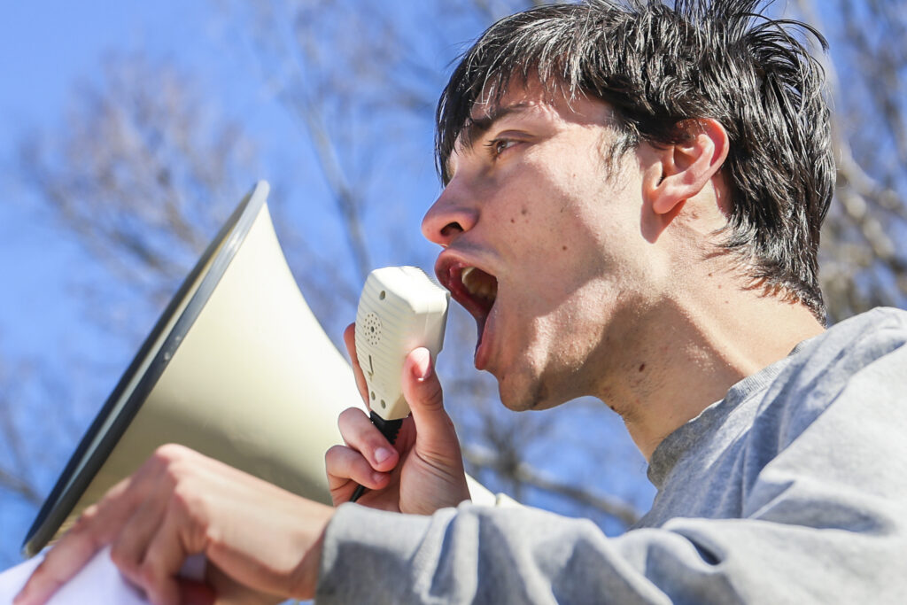 A person shouts into a megaphone