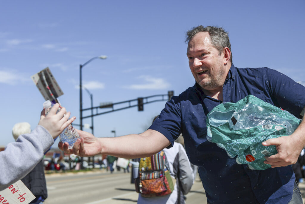 A person handing out water bottles