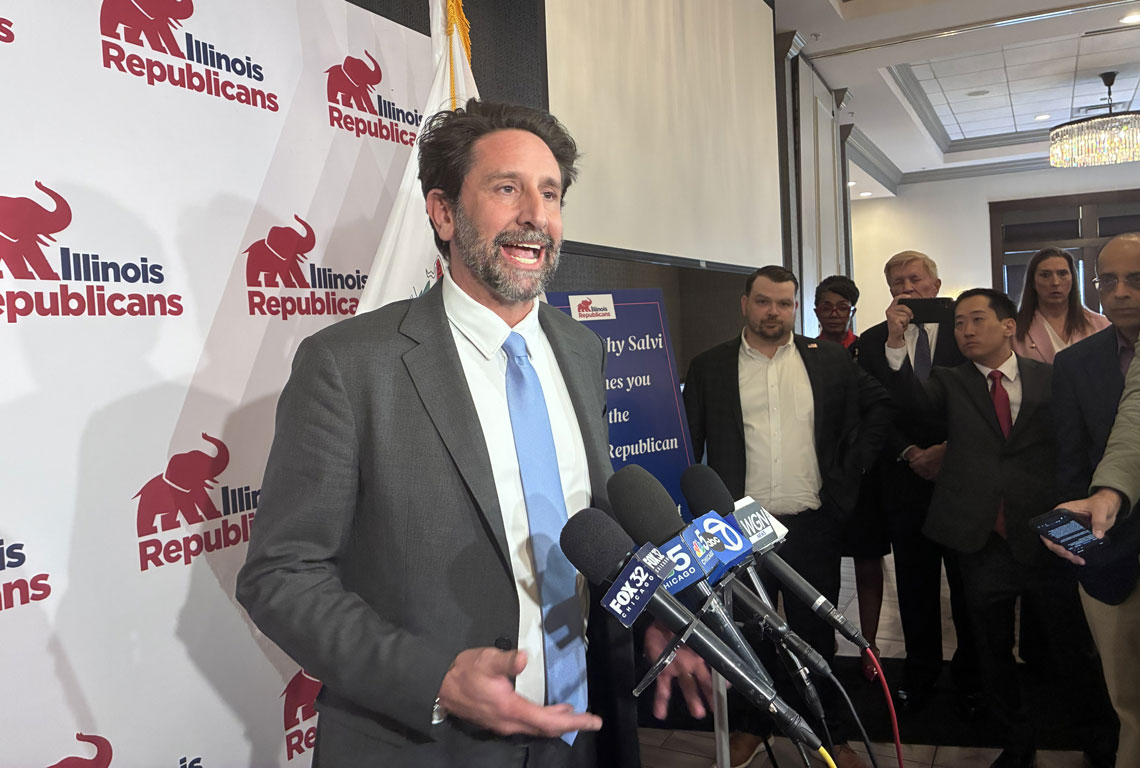 man speaking to reporters