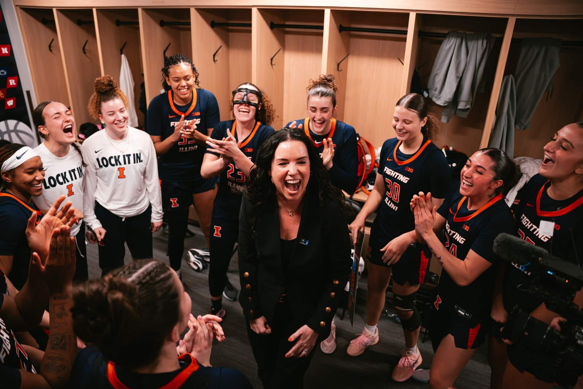 basketball coach and players celebrate