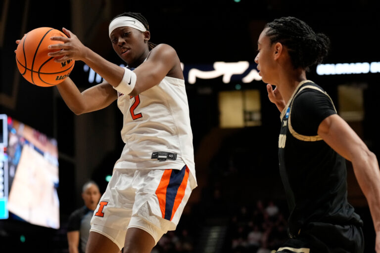 basketball player holds basketball