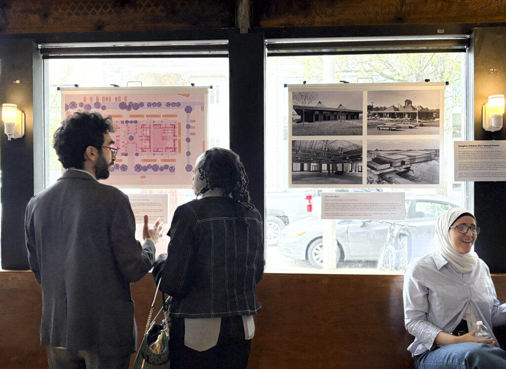 two people look at an art exhibit