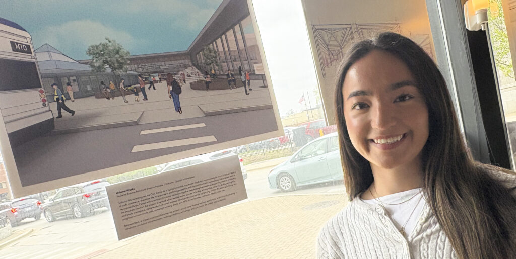 A person stands in front of an image of a building