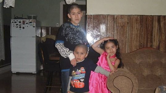 three children pose for a photo