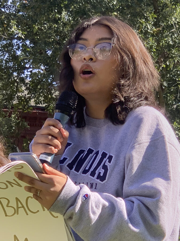 a woman speaks into a microphone