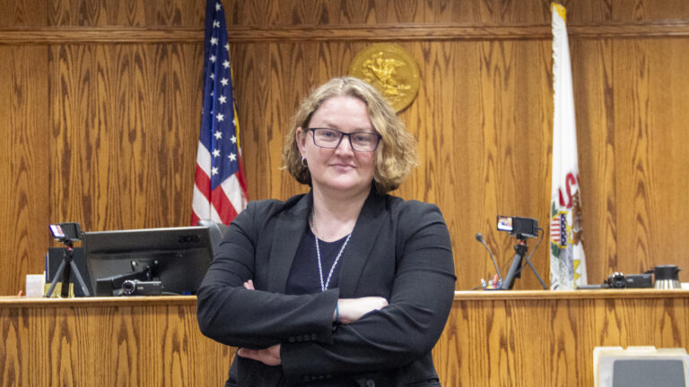 A woman stands in a courtroom