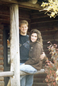 A young couple pose for a photo outside