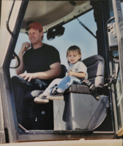 a man and a little boy in a tractor