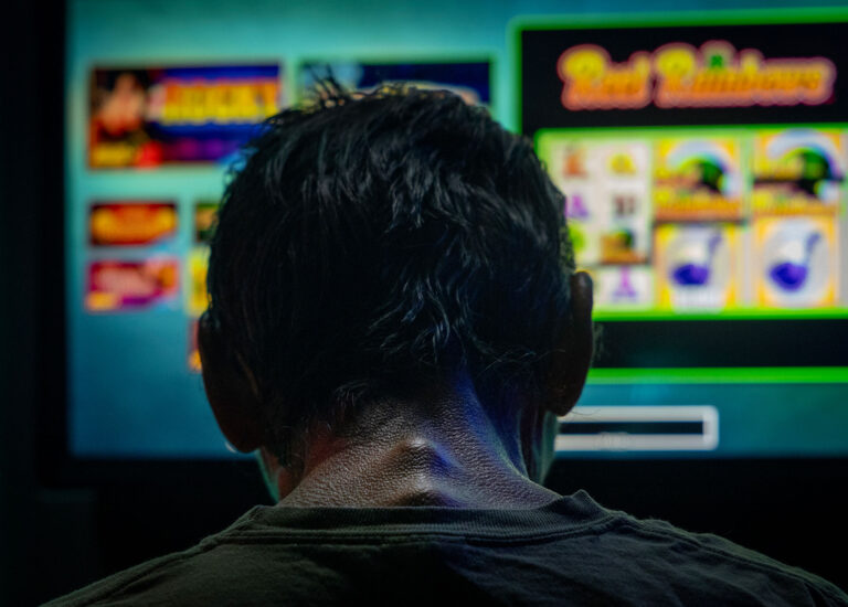 A man spends the last three dollars in his pocket playing a bar slot machine in downstate Golconda on June 4, and then leaves.