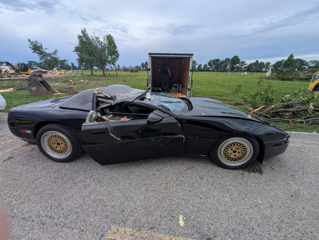 A smashed black Corvette