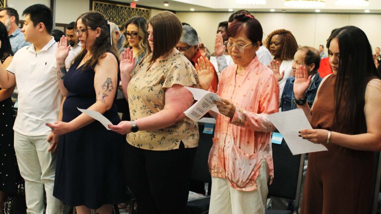 Sing Ing Carter (second from right) takes the naturalization oath in Urbana on Thursday, July 2, 2026.