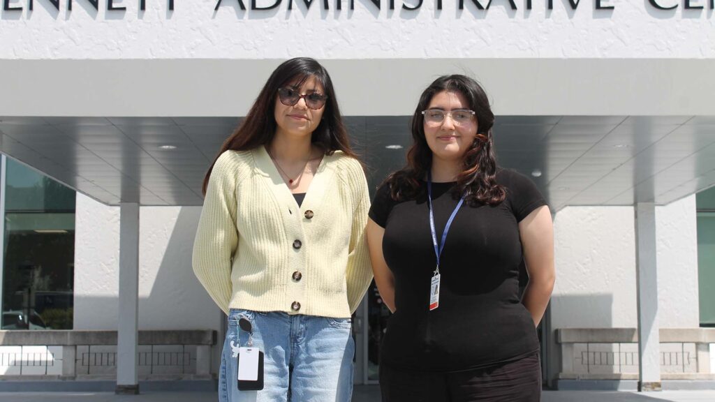 Two young women stand in front of the Champaign County administrative building.