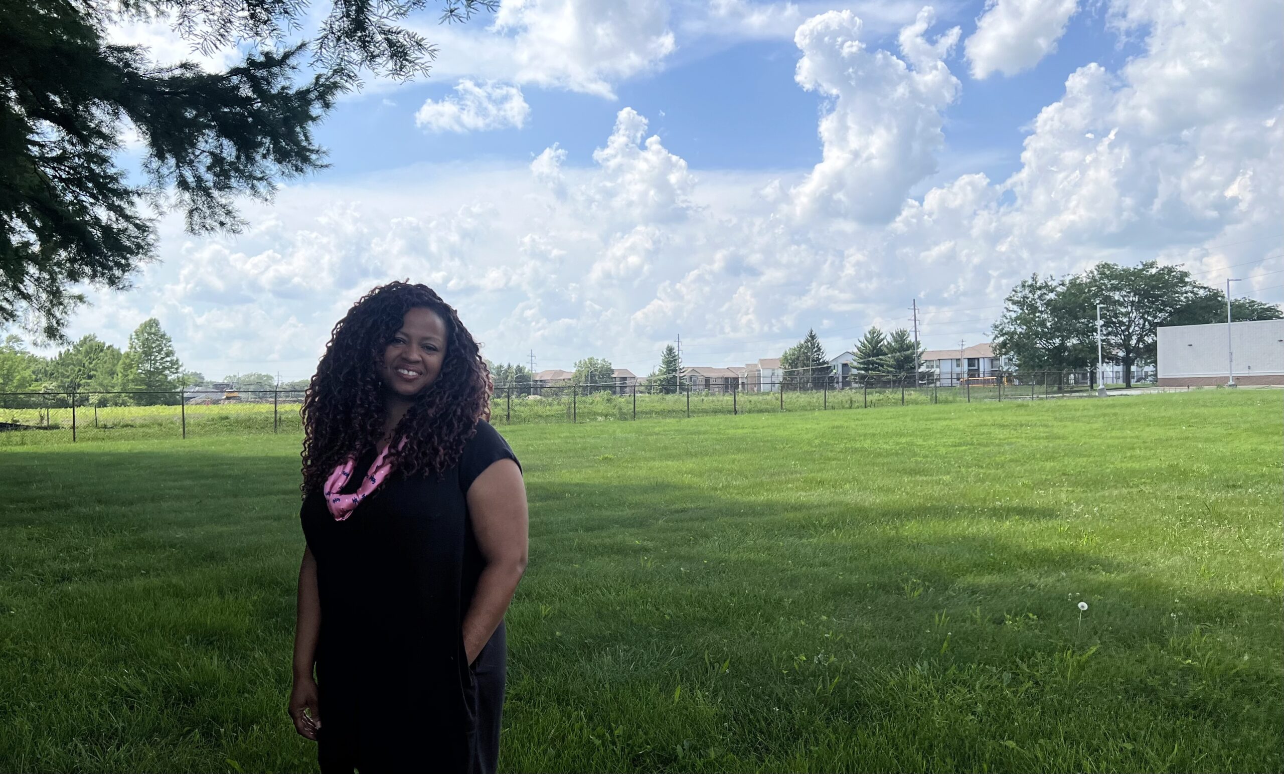 Angela Bradley standing in front of land where grocery store will be built.