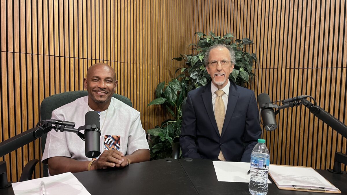 two men sitting in podcast studio at IPM.