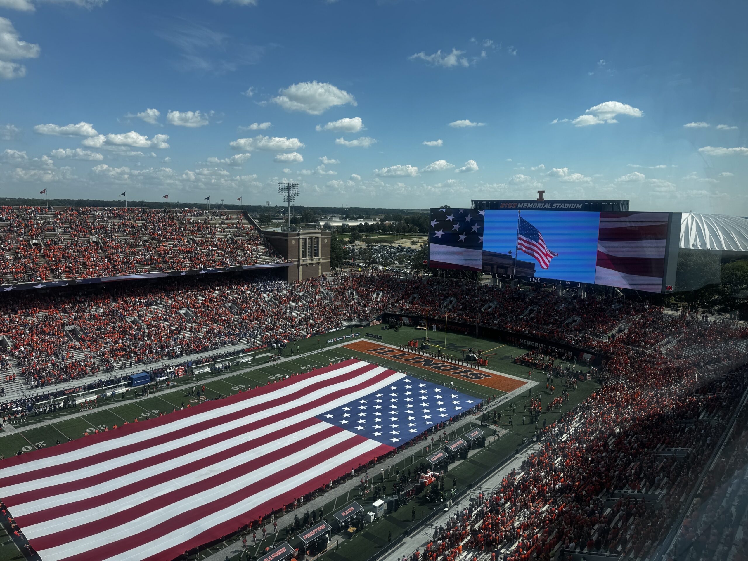 Fans and attendees paused for a moment of silence honoring the victims and first responders of 9/11 as an American flag is unfurled on the field.
