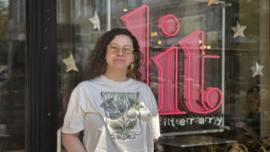a person stands in front of a sign that says "lit"